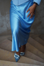 Another lifestyle shot with the satin flared skirt in light blue paired with heeled mule, close up of the chic modest outfit