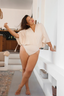 Back view of the plus-size Camila One Piece modest swimsuit with Real Wrap Skirt in cream, offering full coverage and elegant design.