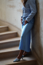 Lifestyle shot of the modest satin flared skirt light blue paired with blue heeled mules