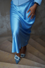 Another lifestyle shot with the satin flared skirt in light blue paired with heeled mule, close up of the chic modest outfit 